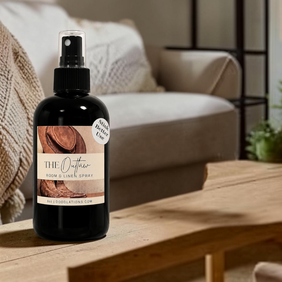 Doodlations Coffee Bar & Boutique The Outlaw room and linen spray in a black bottle with a western-themed label.