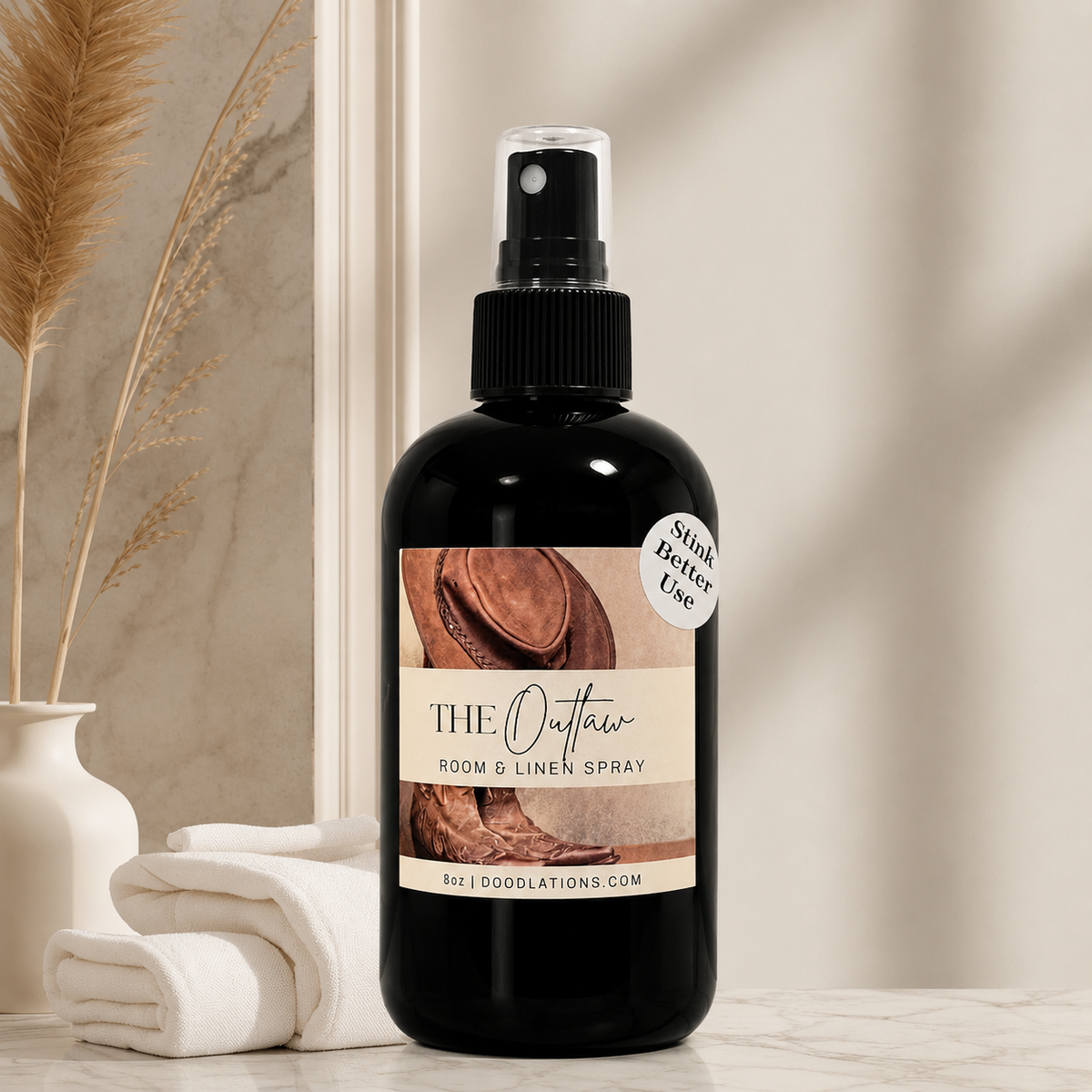 Doodlations Coffee Bar & Boutique The Outlaw room and linen spray in a black bottle with a western-themed label.