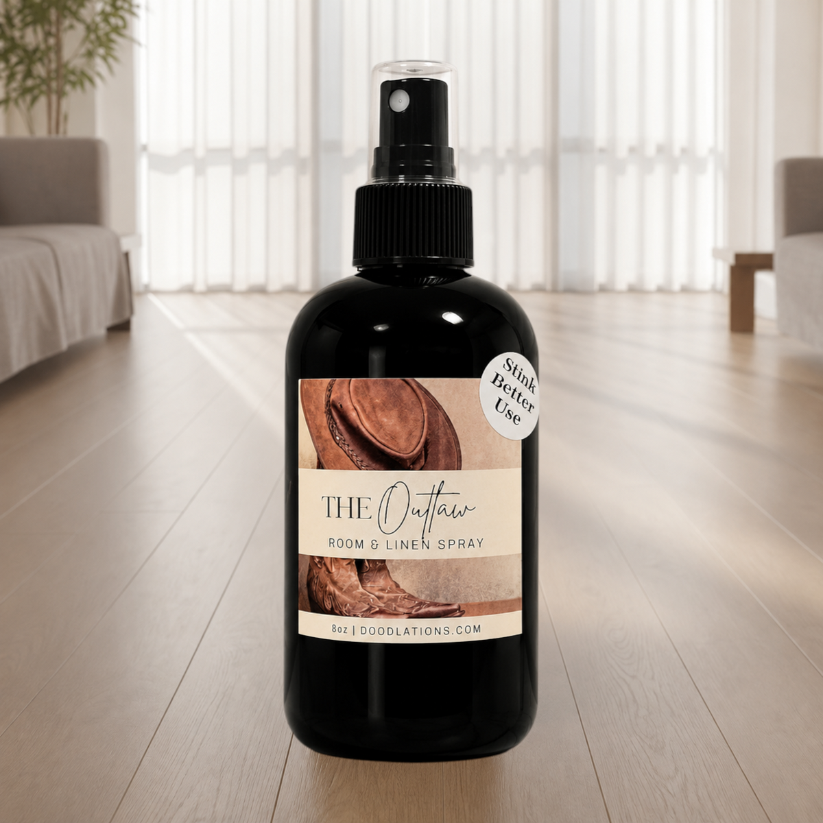 Doodlations Coffee Bar & Boutique The Outlaw room and linen spray in a black bottle with a western-themed label.