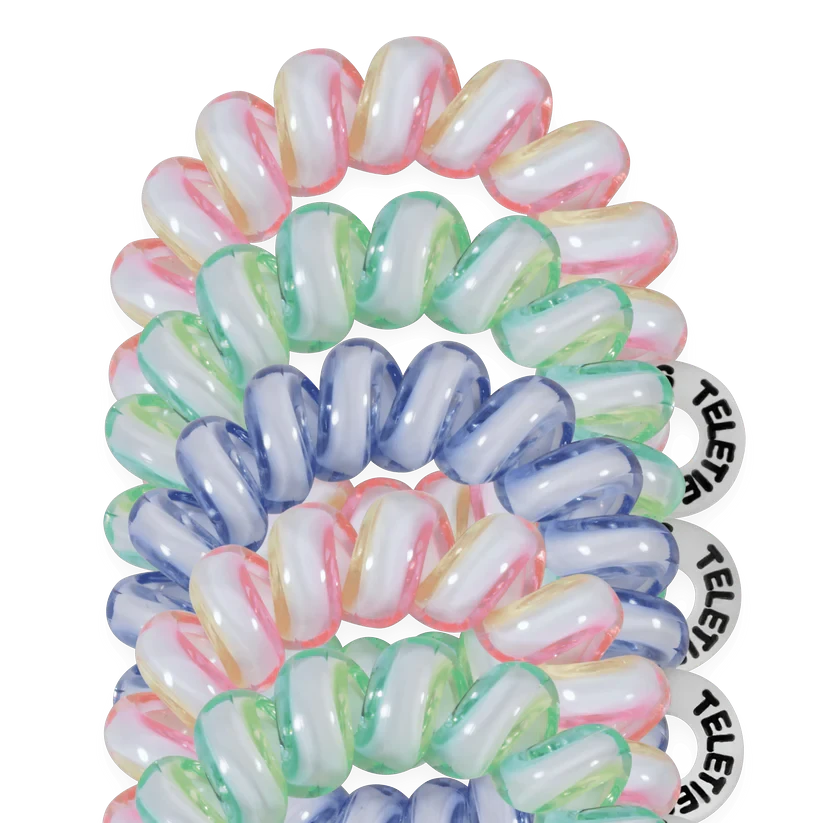 Doodlations Coffee Bar & Boutique Shades of Summer tiny coil hair ties in pastel pink, green, and blue on black.