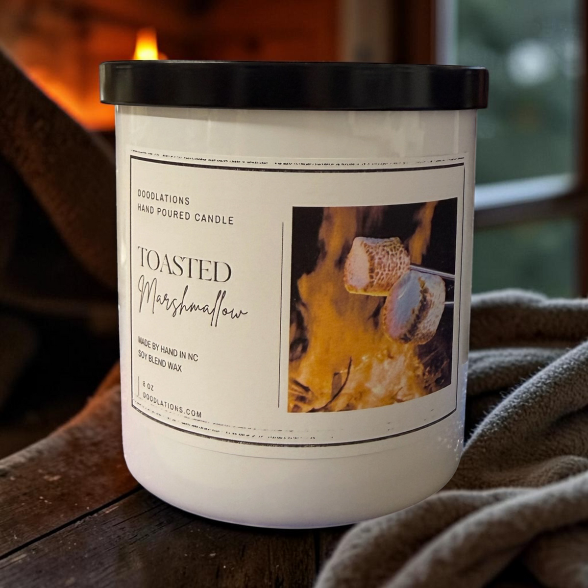Doodlations Coffee Bar & Boutique Toasted Marshmallow soy blend candle in a white jar with a black lid