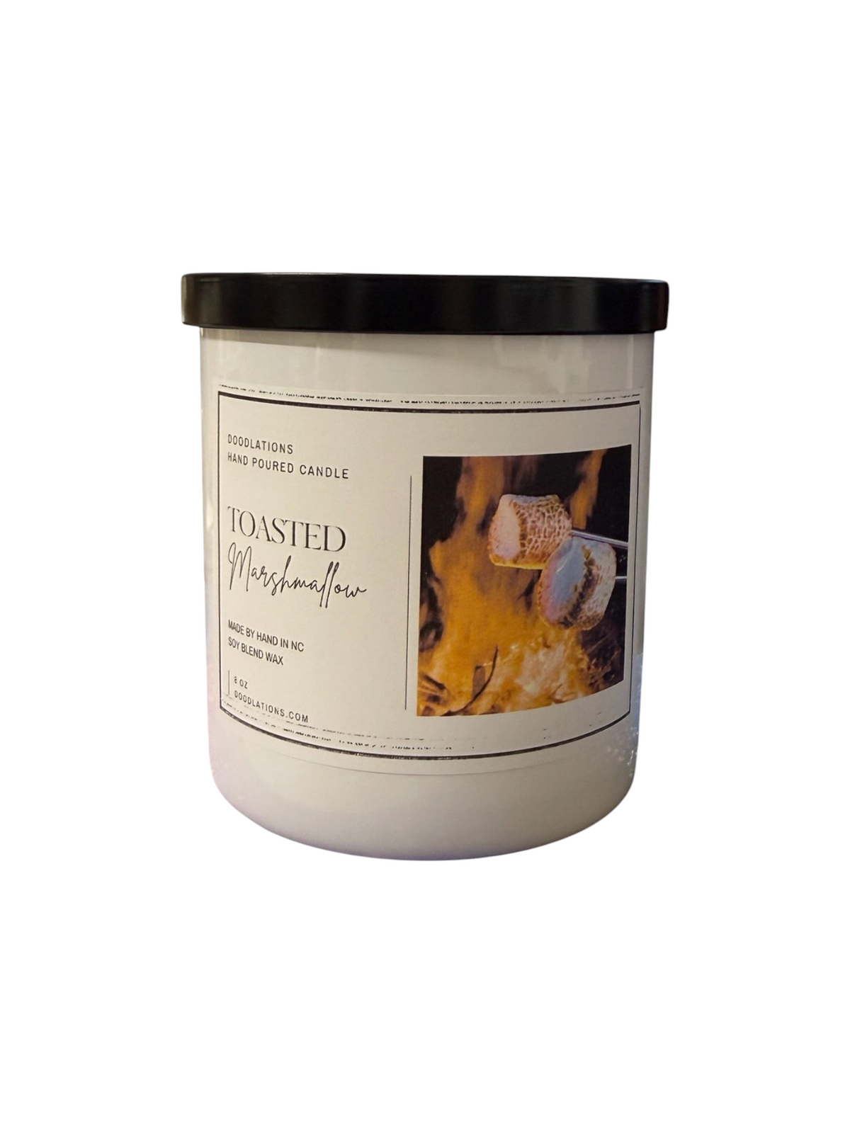 Doodlations Coffee Bar & Boutique toasted marshmallow scented candle in a white jar with a black lid