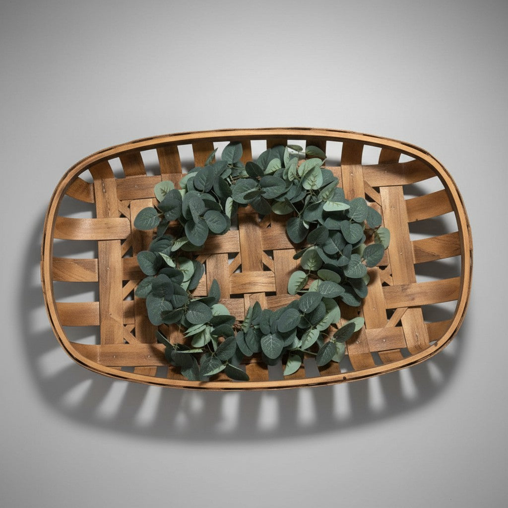 Doodlations Coffee Bar & Boutique tobacco basket with greenery wreath. Rustic wooden basket with eucalyptus garland.