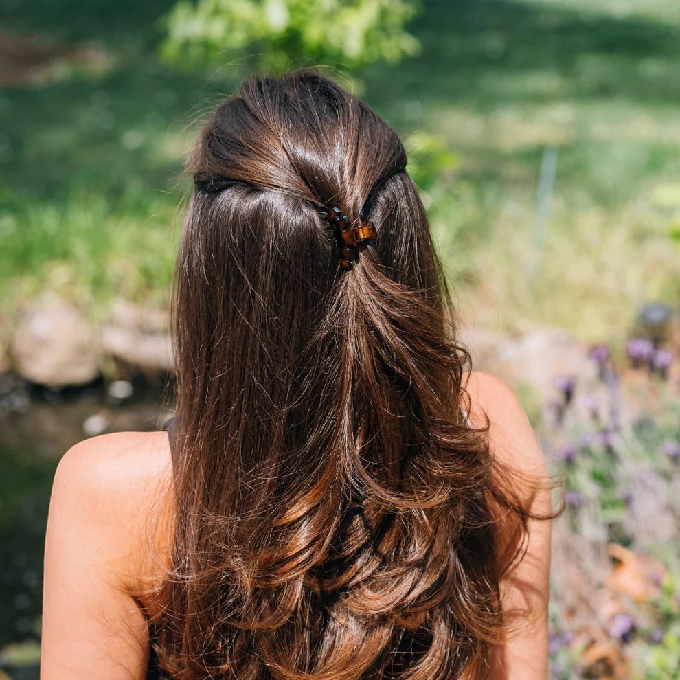 Doodlations Coffee Bar & Boutique classic tortoise claw hair clip securing a half-up hairstyle on long brown hair