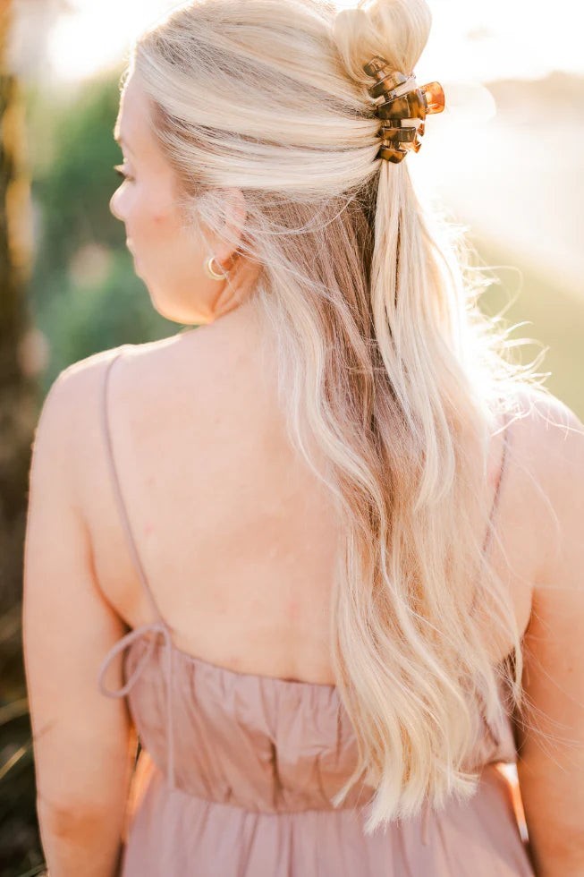 Doodlations Coffee Bar & Boutique classic tortoise shell claw hair clip holding blonde hair in a half-up style