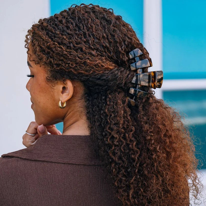 Doodlations Coffee Bar & Boutique classic tortoise shell claw hair clip holding curly hair in a half-up style