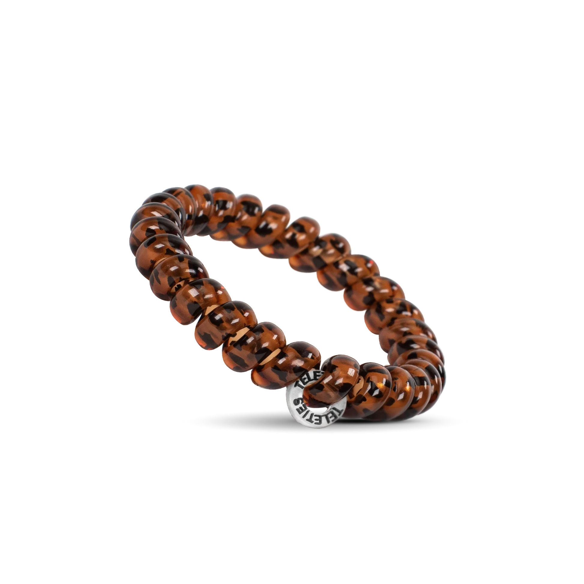 Doodlations Coffee Bar & Boutique tortoise shell spiral hair tie with a silver charm on a black background