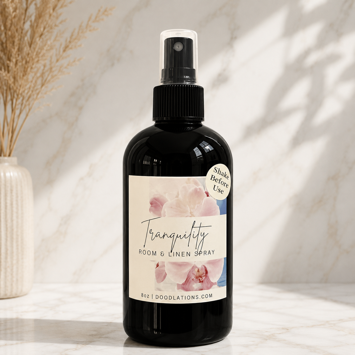 Doodlations Coffee Bar & Boutique Tranquility room and linen spray in a black bottle with a floral label on marble