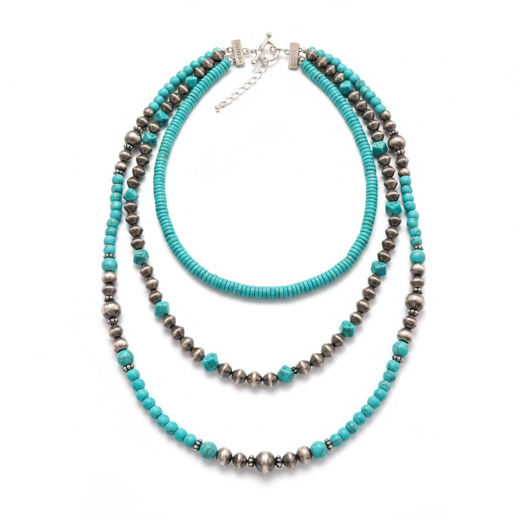 Doodlations Coffee Bar & Boutique layered statement necklace featuring turquoise beads and metallic silver accents.