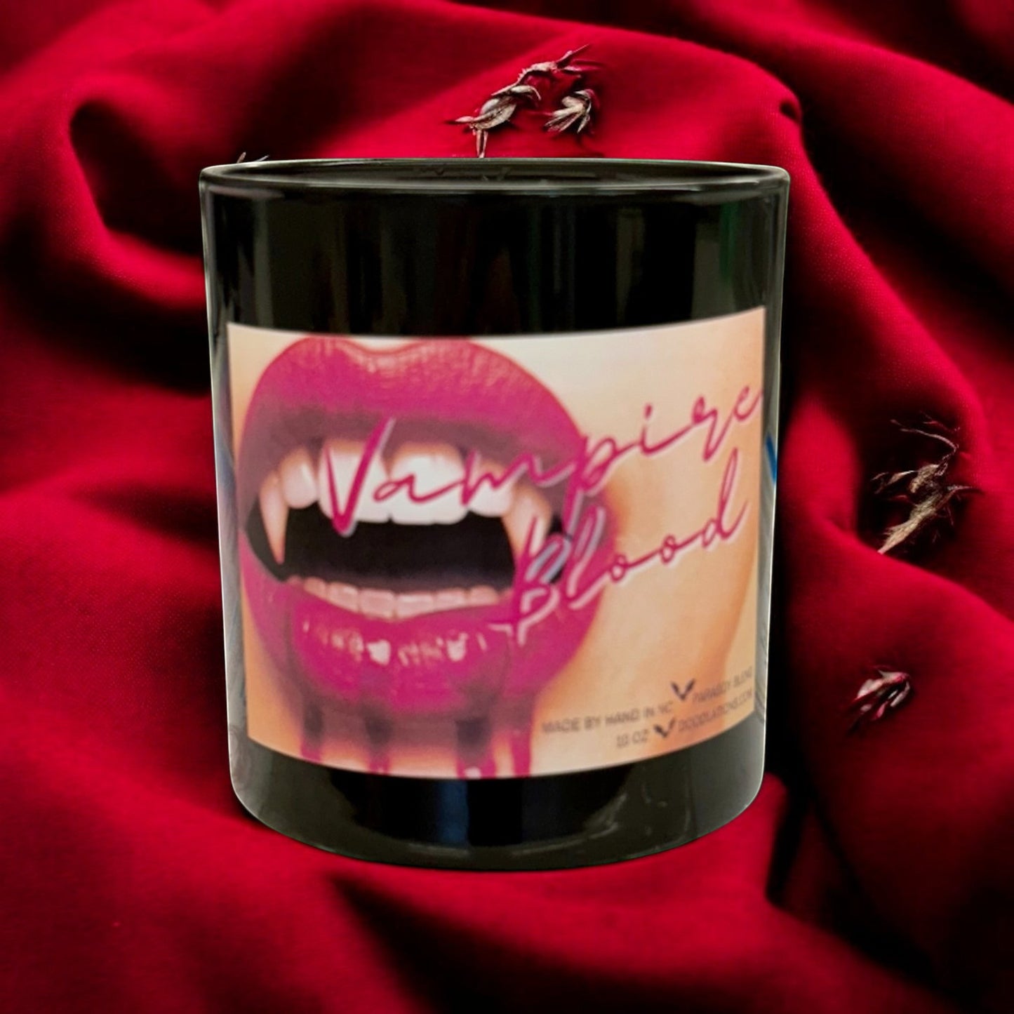 Doodlations Coffee Bar & Boutique Vampire Blood luxury candle with decorative wax fangs and bats. Bold berry, jasmine, amber scent.