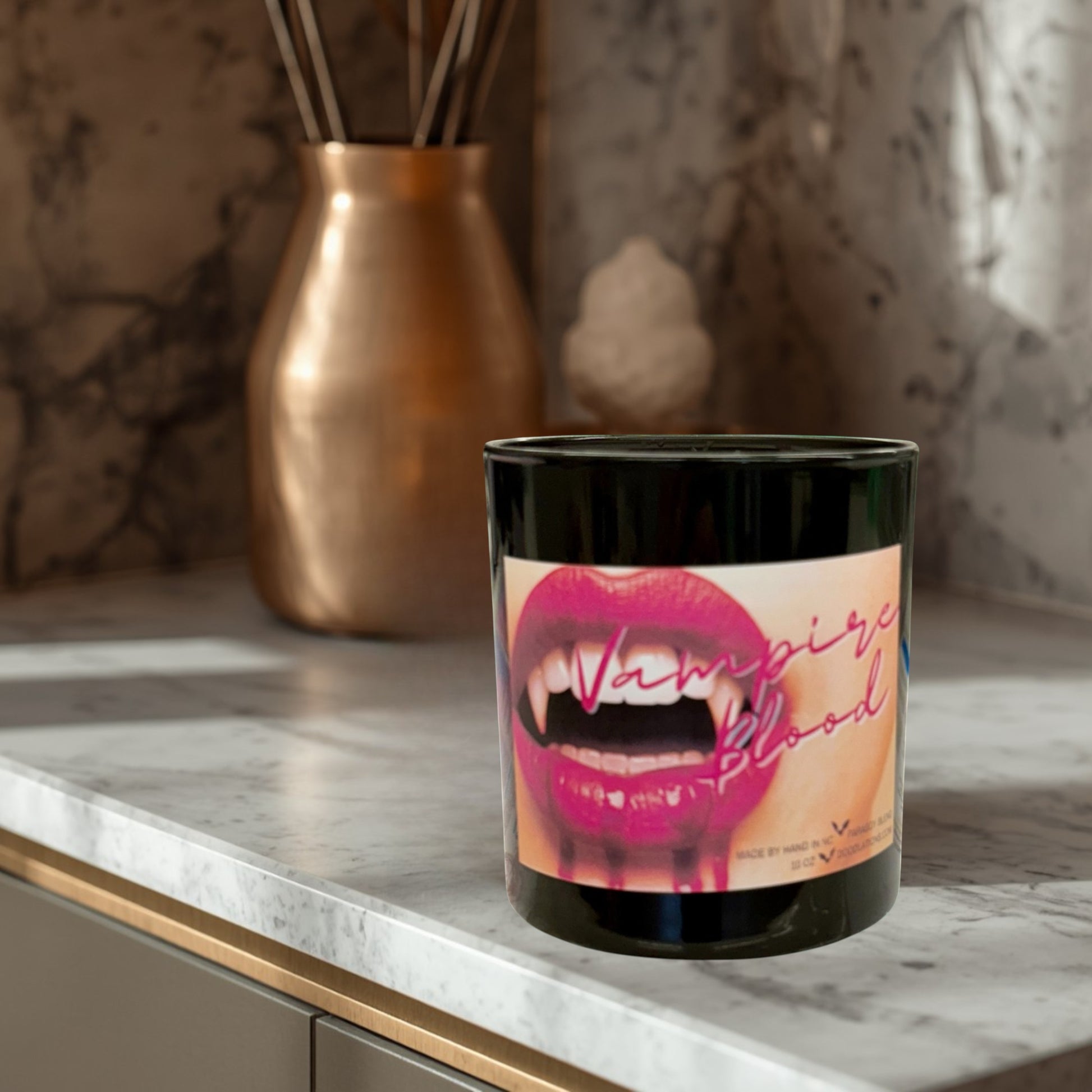 Doodlations Coffee Bar & Boutique Vampire Blood luxury candle with decorative wax fangs and bats. Dark berry, jasmine, amber scent.