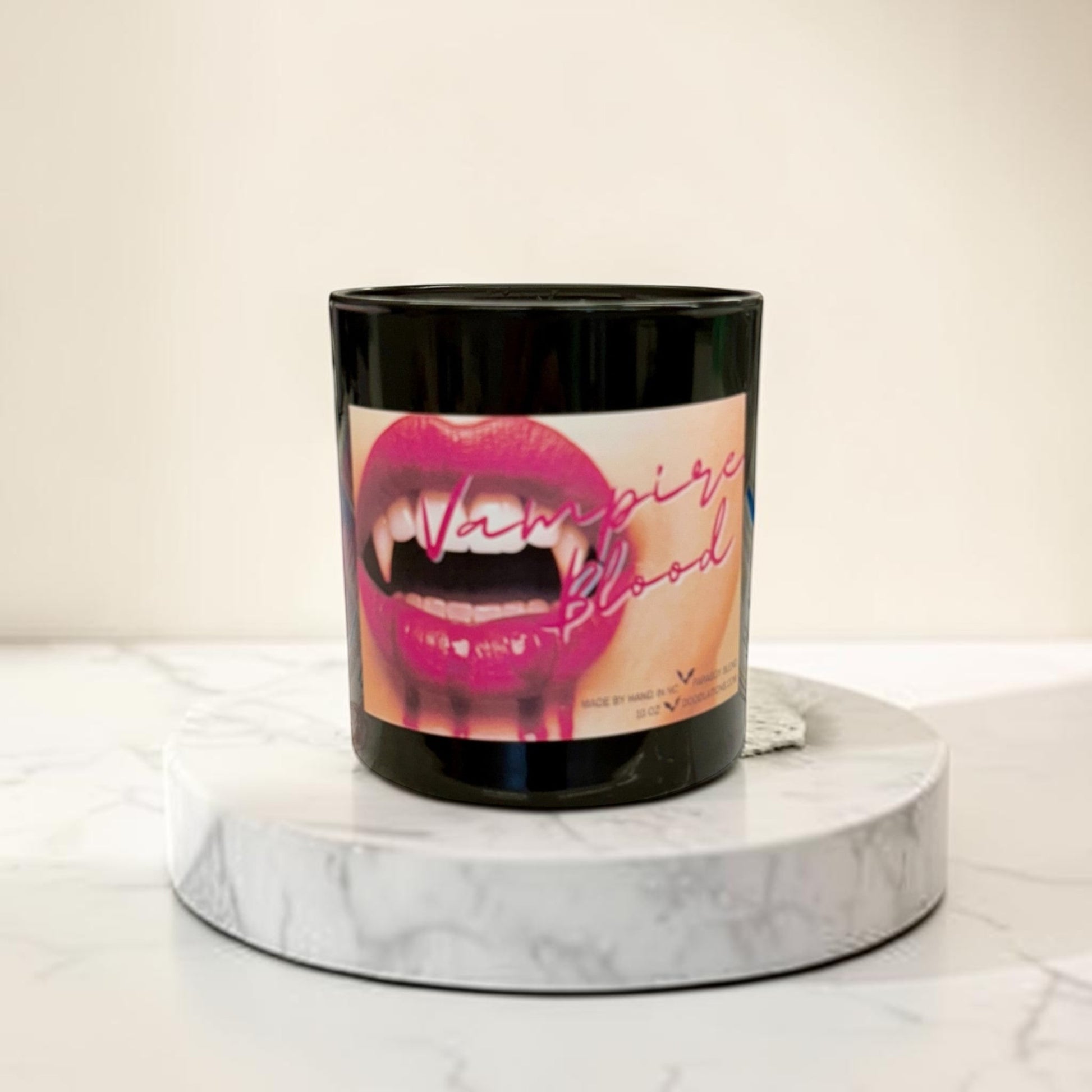 Doodlations Coffee Bar & Boutique Vampire Blood luxury candle with decorative wax fangs and bats. Bold mysterious scent.