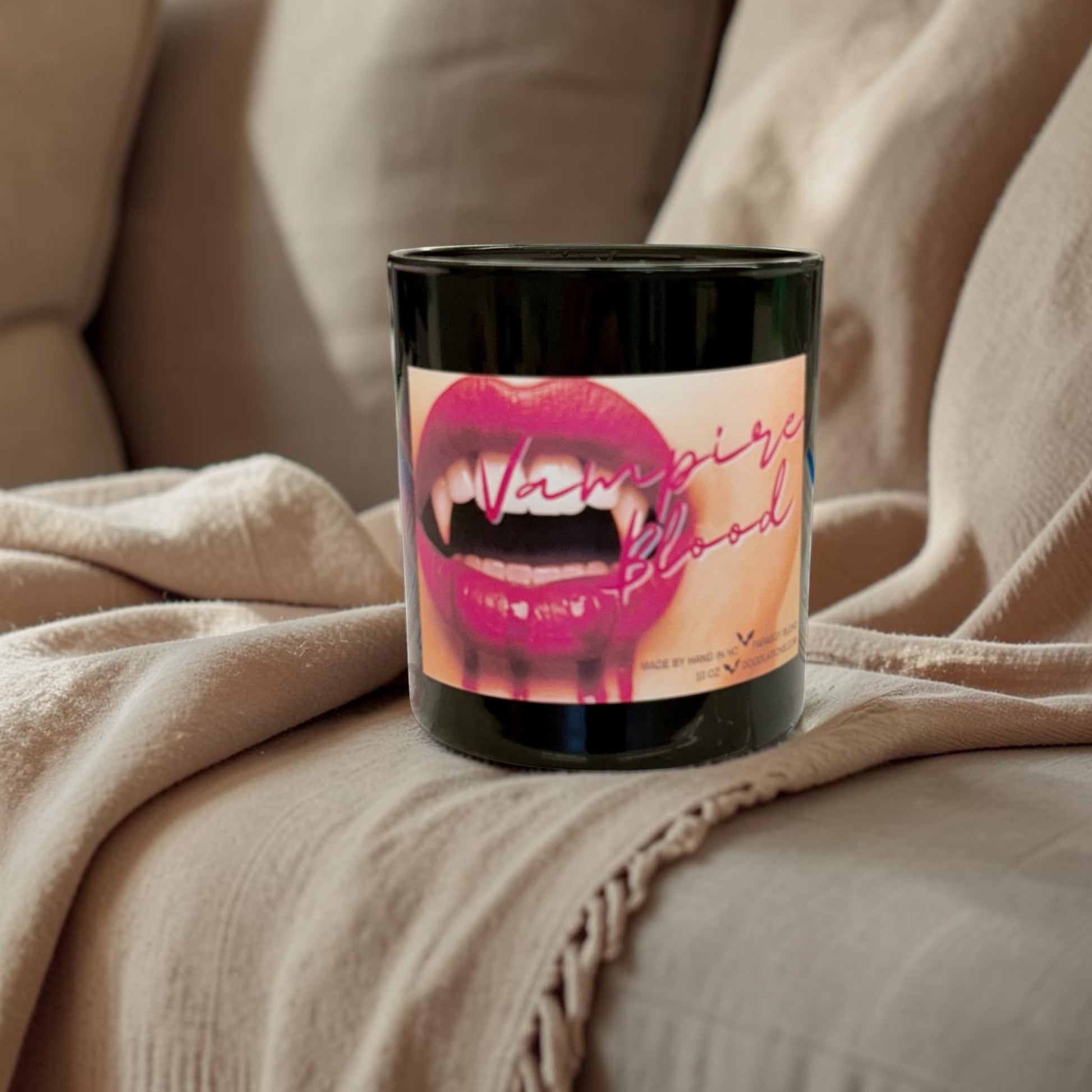 Doodlations Coffee Bar & Boutique Vampire Blood luxury candle with decorative wax fangs and bats. Bold berry, jasmine, amber scent.