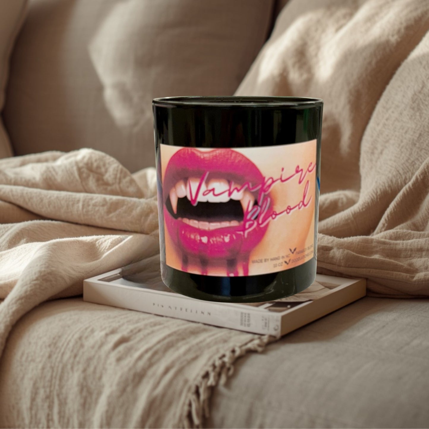 Doodlations Coffee Bar & Boutique Vampire Blood luxury candle with decorative wax fangs and bats. Bold berry, jasmine, amber scent.