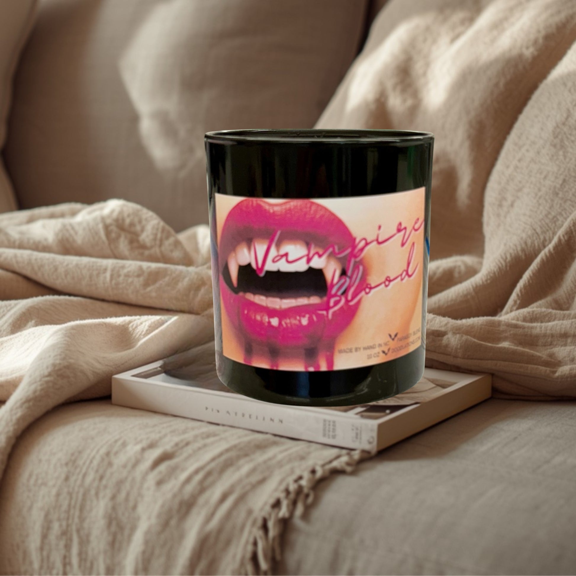 Doodlations Coffee Bar & Boutique Vampire Blood luxury candle with decorative wax fangs and bats. Bold berry, jasmine, amber scent.