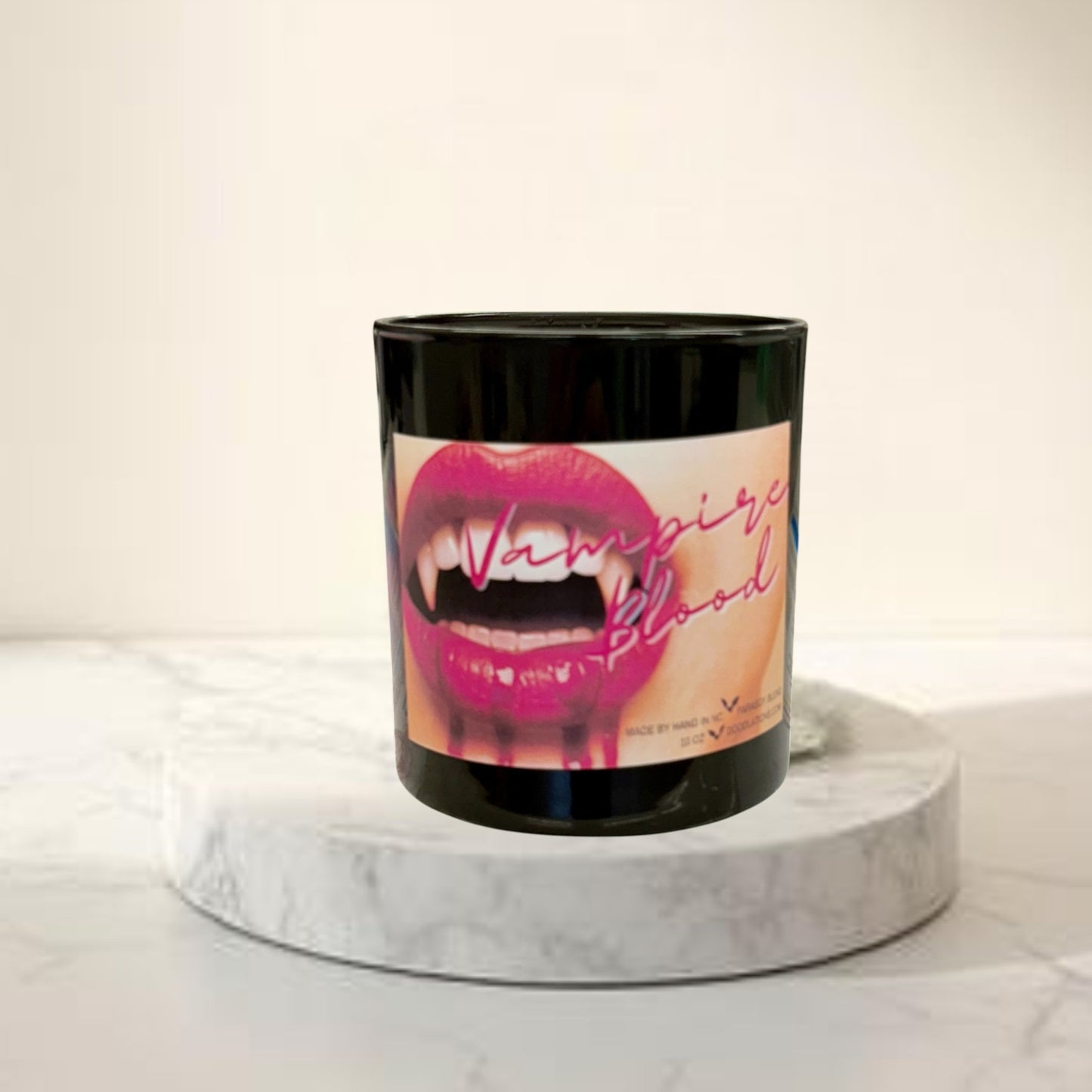 Doodlations Coffee Bar & Boutique Vampire Blood luxury candle with decorative wax fangs and bats. Bold mysterious scent.