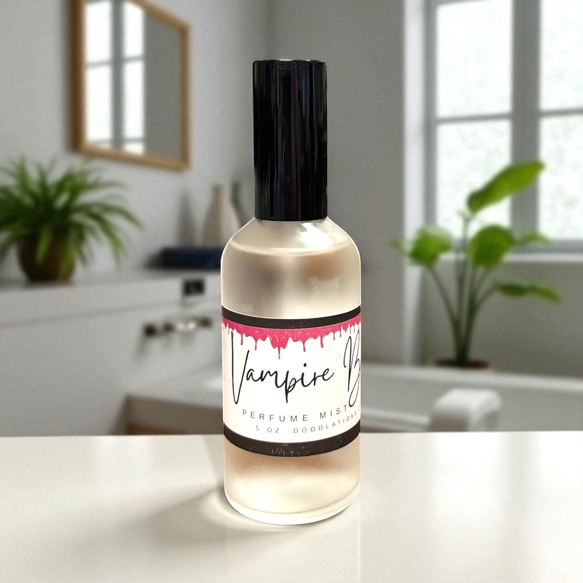Doodlations Coffee Bar & Boutique Vampire Blood fine mist perfume in a clear glass bottle with a black cap.