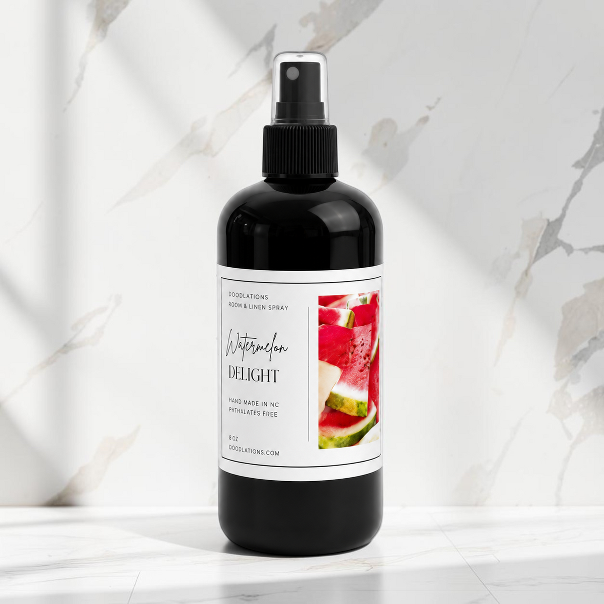 Doodlations Coffee Bar & Boutique Watermelon Delight room and linen spray in a black bottle with a white label.