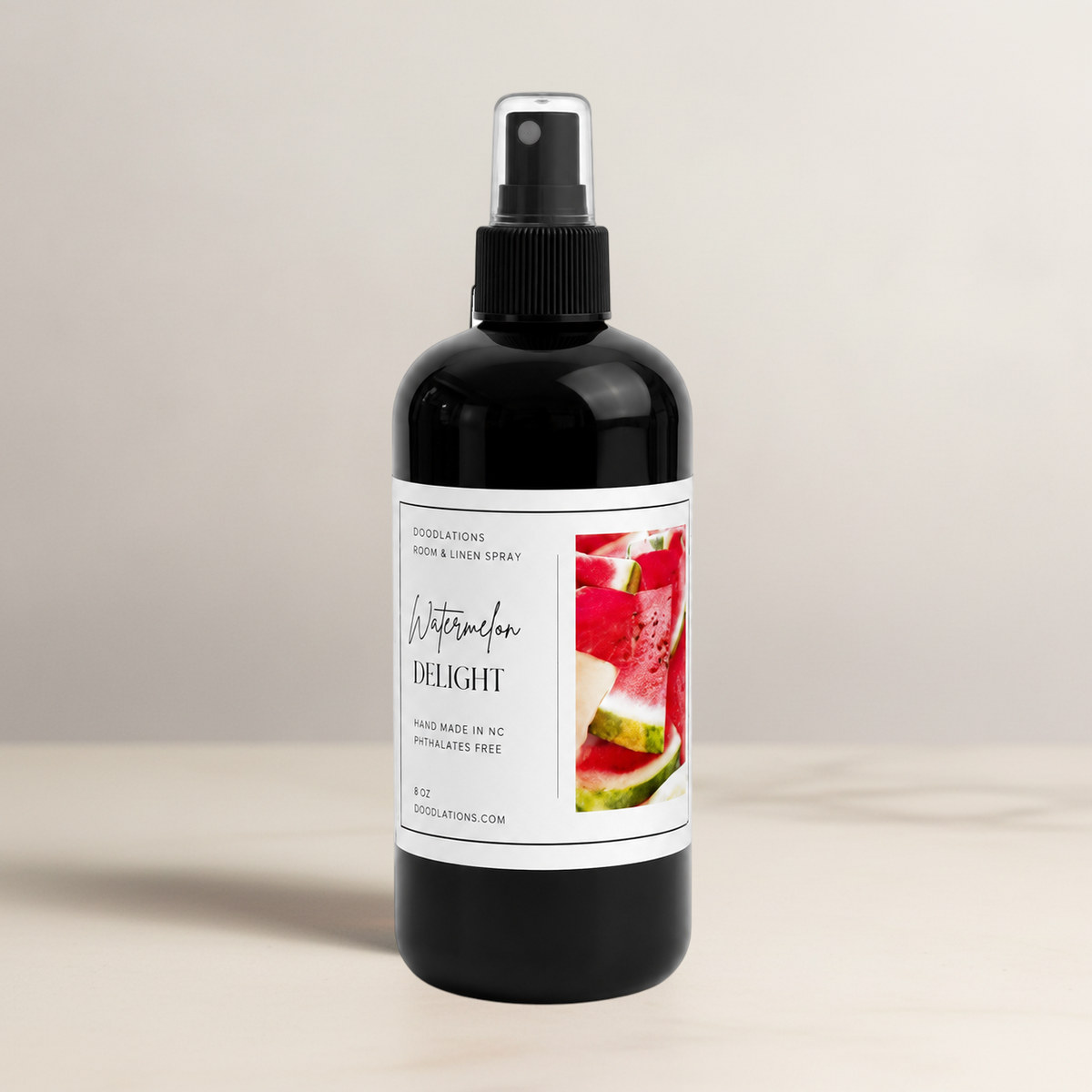 Doodlations Coffee Bar & Boutique Watermelon Delight room and linen spray in a black bottle with a white label.