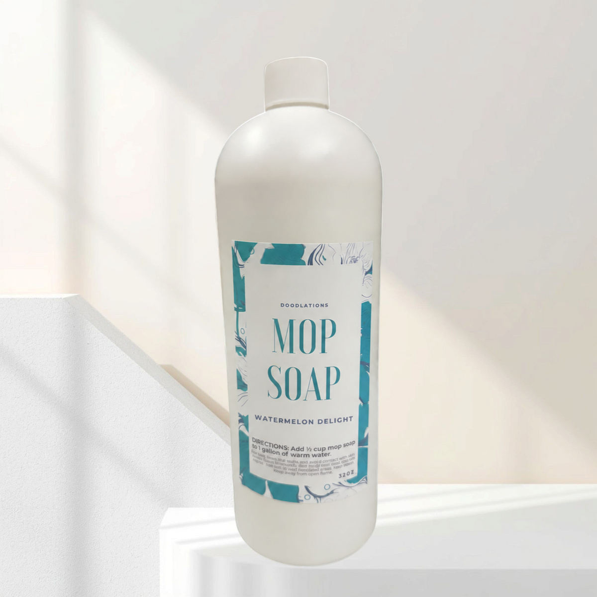 Doodlations Coffee Bar & Boutique 32 oz Watermelon Delight concentrated mop soap bottle on a marble counter