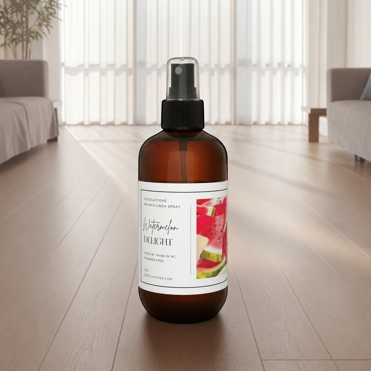 Doodlations Coffee Bar & Boutique Watermelon Delight room and linen spray in an amber bottle on a wooden floor.