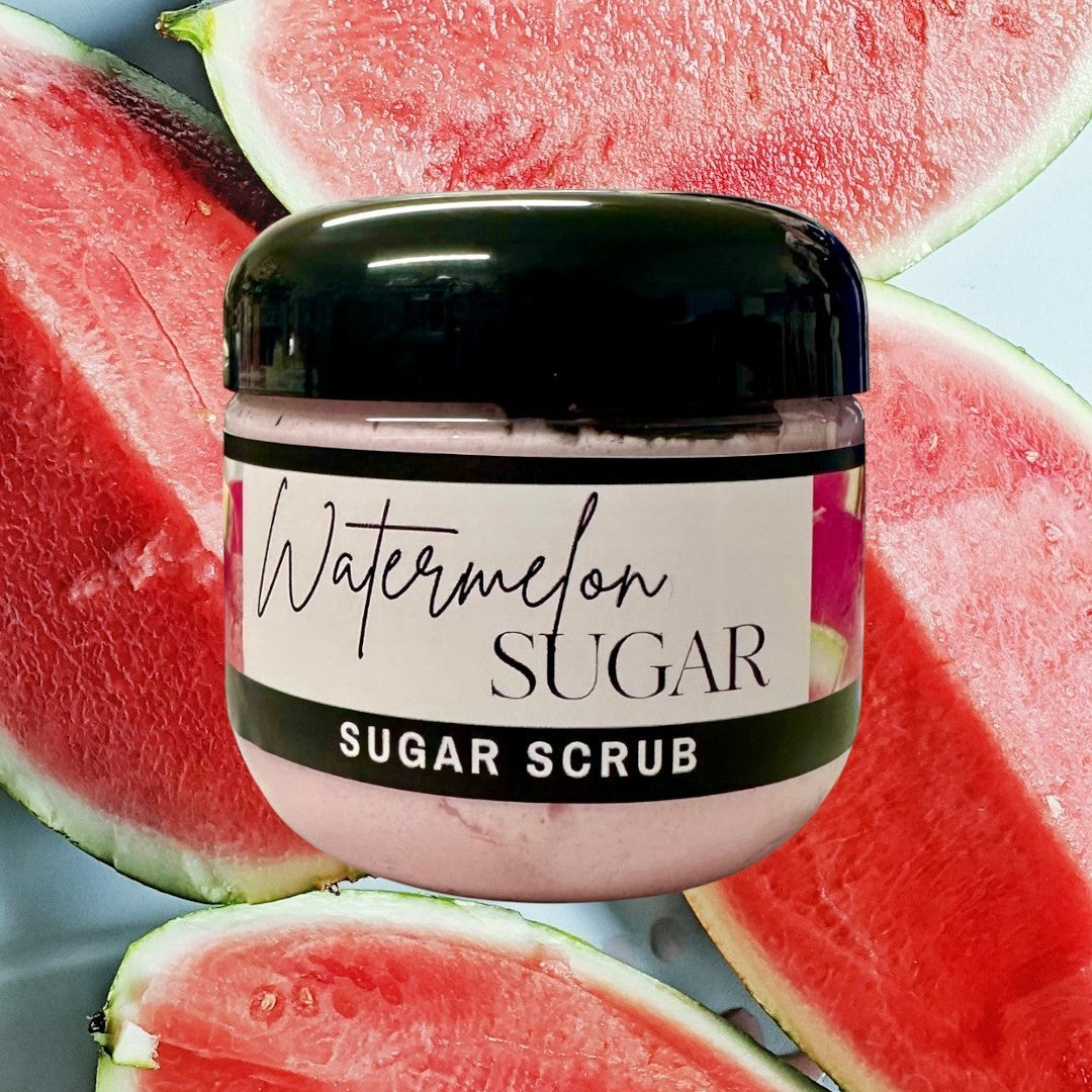 Doodlations Coffee Bar & Boutique Watermelon Sugar Scrub in a clear jar with a black lid. Pink scrub with a watermelon slice graphic.