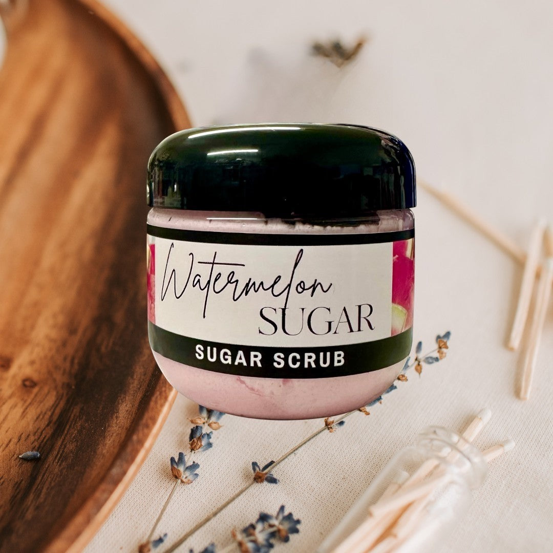 Doodlations Coffee Bar & Boutique Watermelon Sugar Scrub in a clear jar with a black lid. Pink scrub with watermelon imagery on the label.