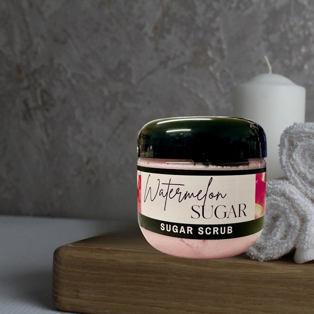 Doodlations Coffee Bar & Boutique Watermelon Sugar Scrub in a clear jar with a black lid, pink scrub inside.