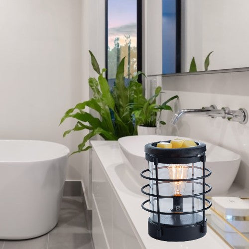 Doodlations black metal and glass wax warmer with vintage bulb and yellow wax melts on top.