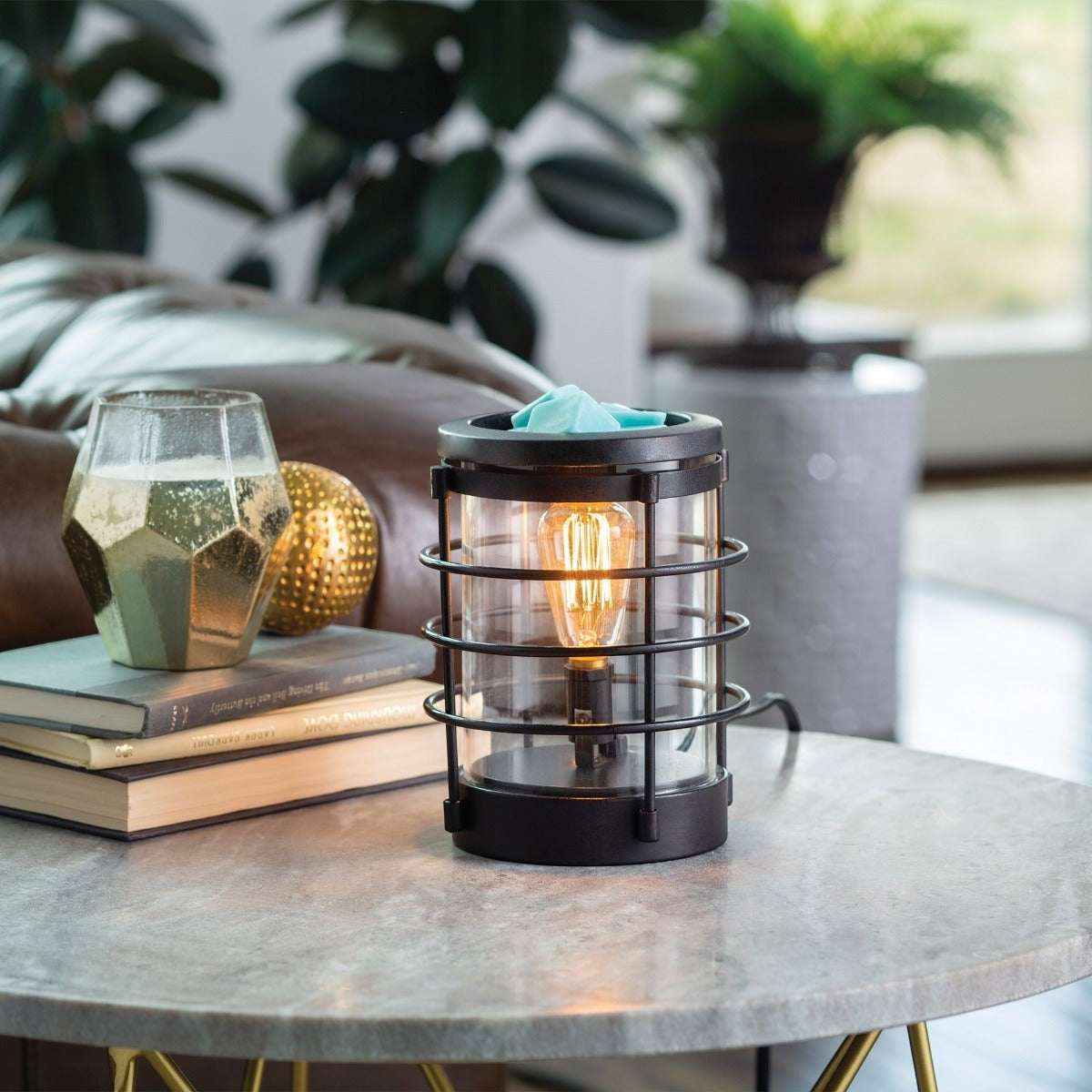 Doodlations Coastal Vintage Bulb Illumination Wax Warmer with black metal cage and glass cylinder, melting blue wax.