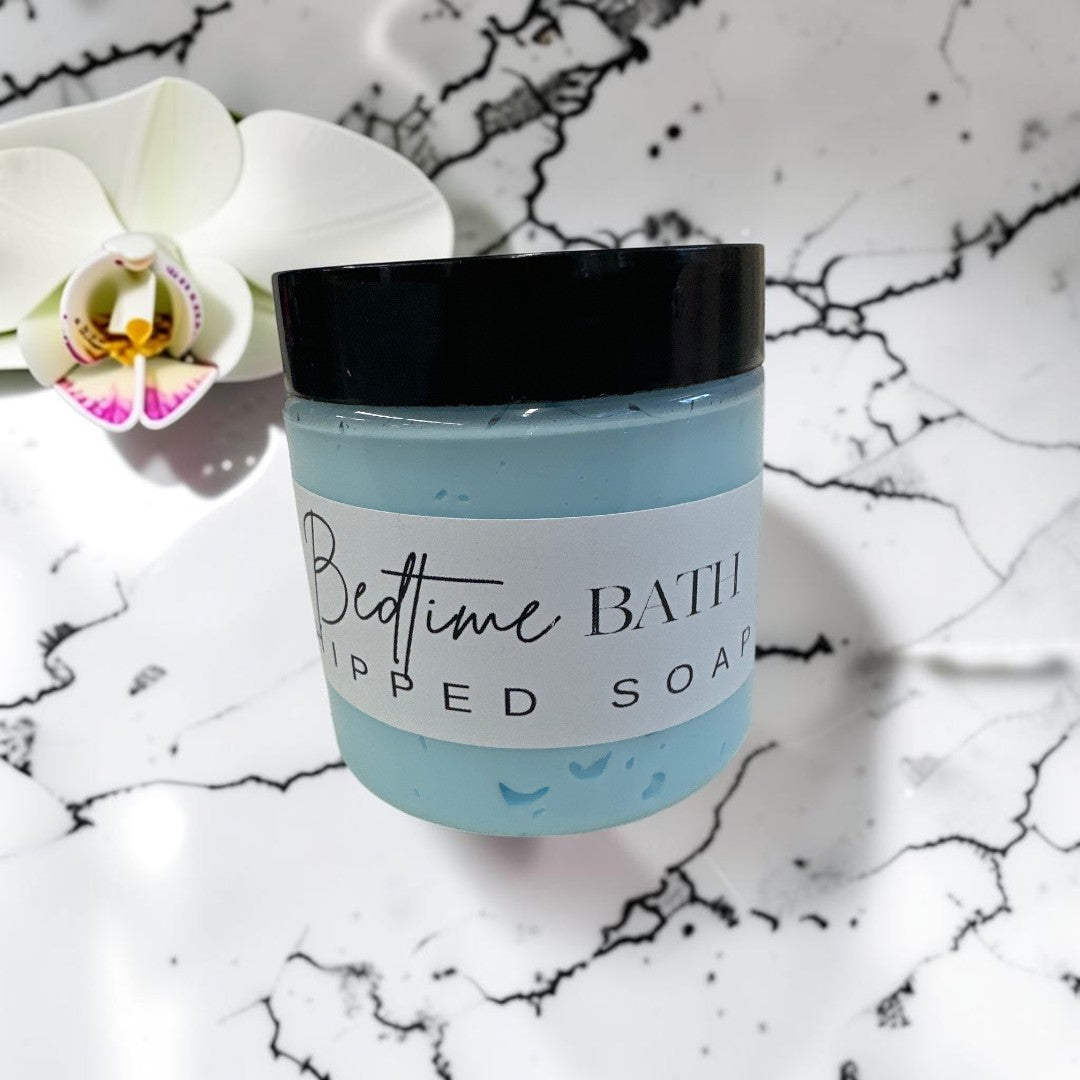 Doodlations Coffee Bar & Boutique Bedtime Bath whipped soap in a light blue jar with a black lid.