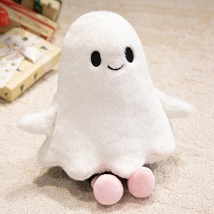 Doodlations Coffee Bar & Boutique white plush ghost toy with embroidered face and small pink feet on a soft surface