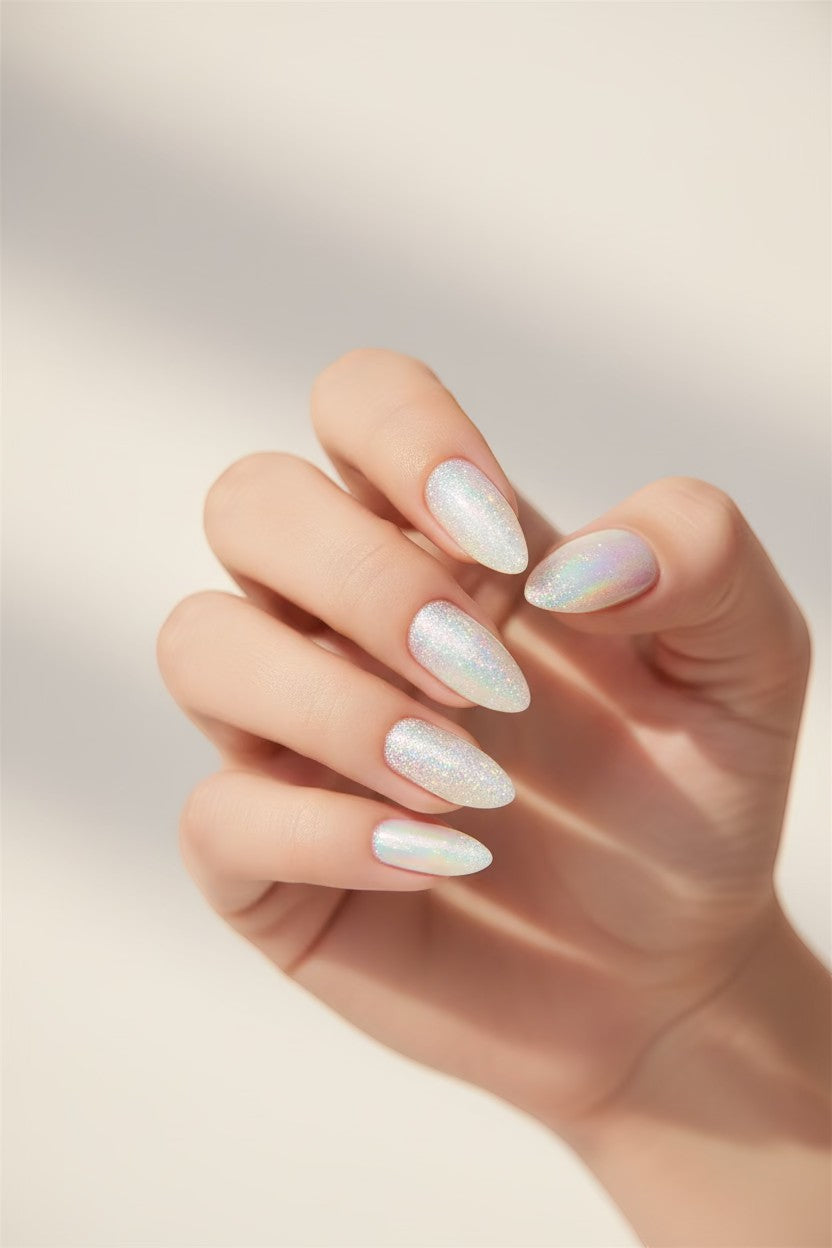 Doodlations Coffee Bar & Boutique white glitter and chrome press-on almond nails with holographic finish.