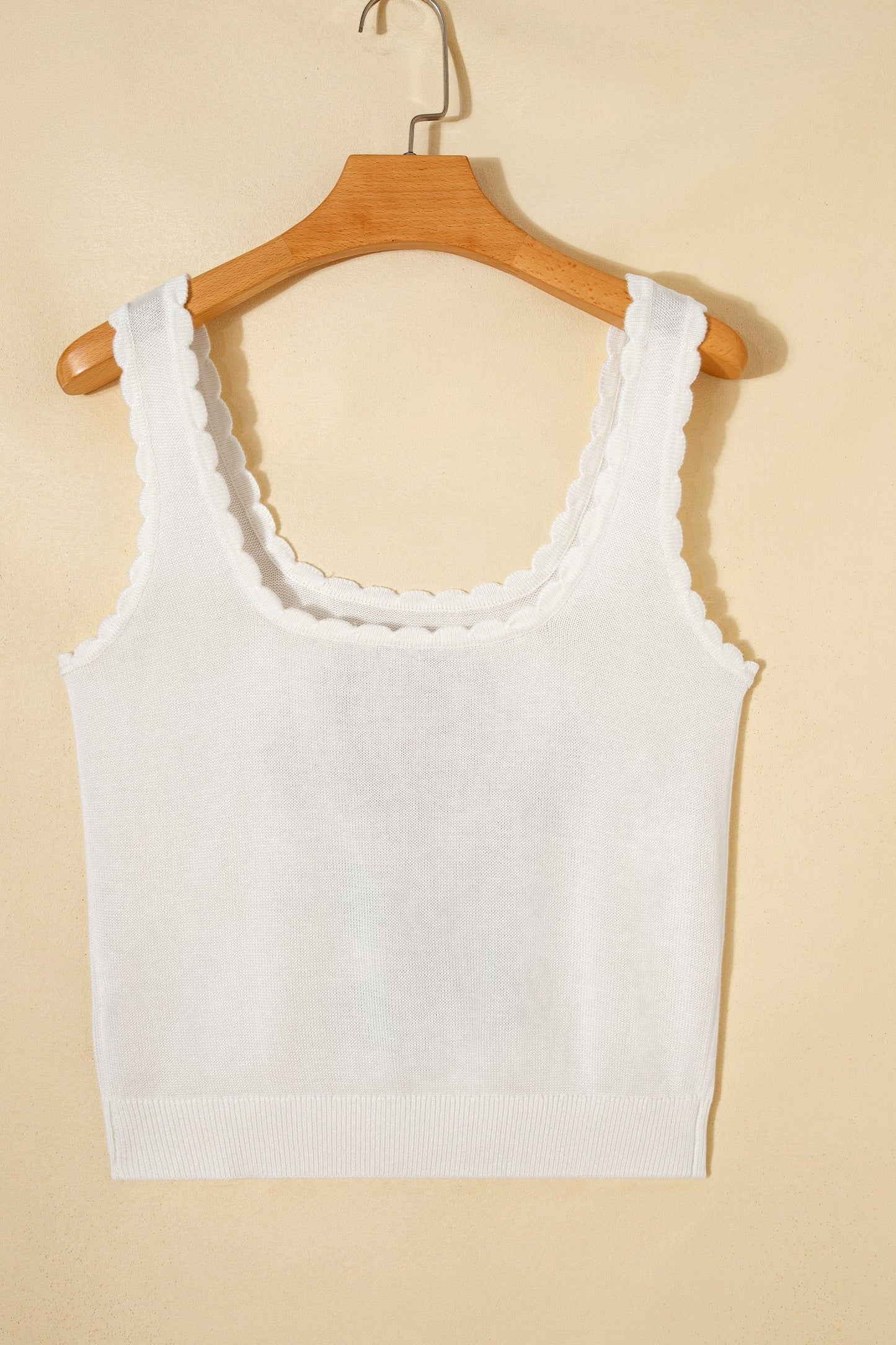 Doodlations Coffee Bar & Boutique white knit tank top with a scoop neckline and delicate scalloped trim edges.