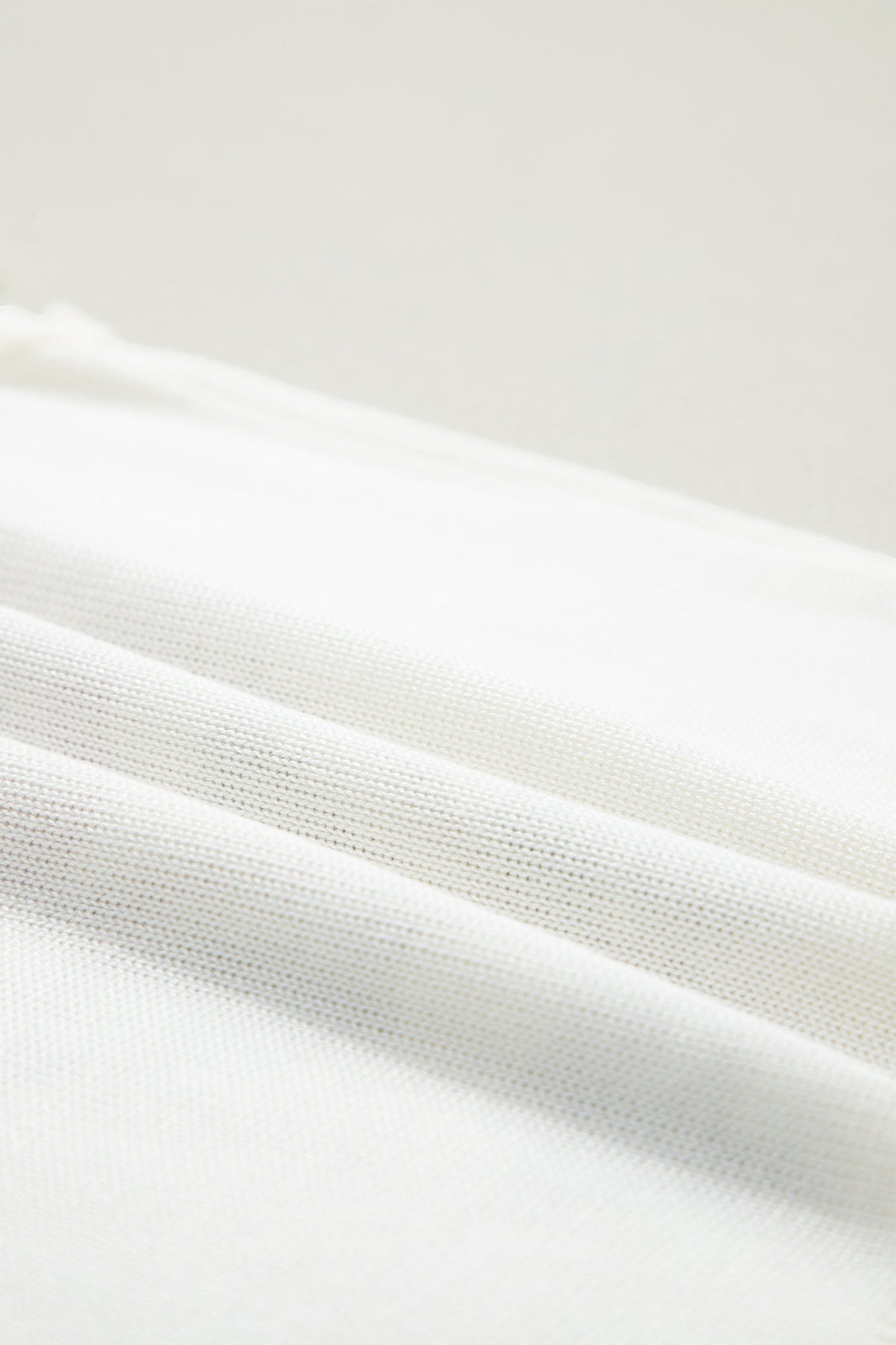 Doodlations Coffee Bar & Boutique white knit fabric texture detail of a floral tank top