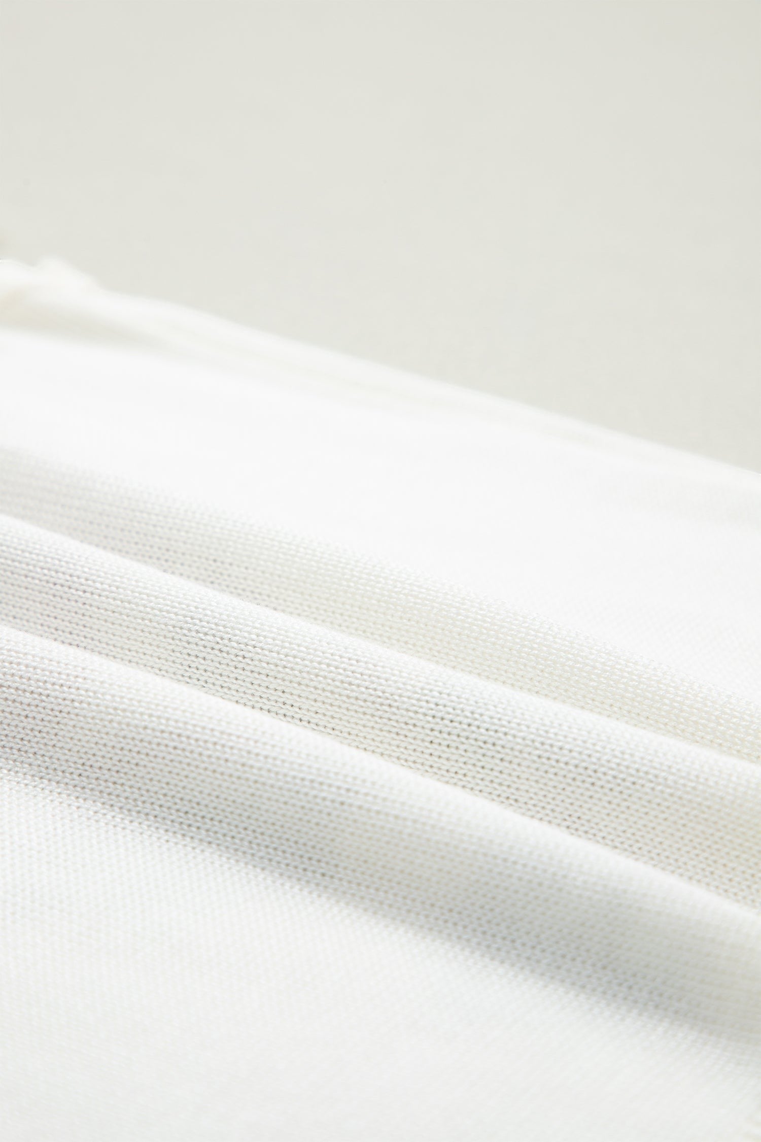 Doodlations Coffee Bar & Boutique white knit fabric texture detail of a floral tank top