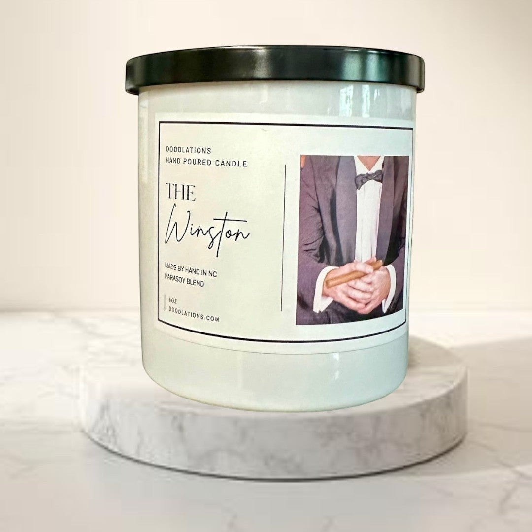 Doodlations Coffee Bar & Boutique The Winston hand-poured soy blend candle with notes of tobacco, honey, amaretto, and oak.