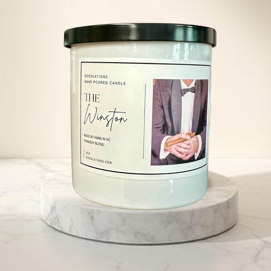 Doodlations Coffee Bar & Boutique The Winston hand-poured soy blend candle with notes of tobacco, honey, amaretto, and oak.