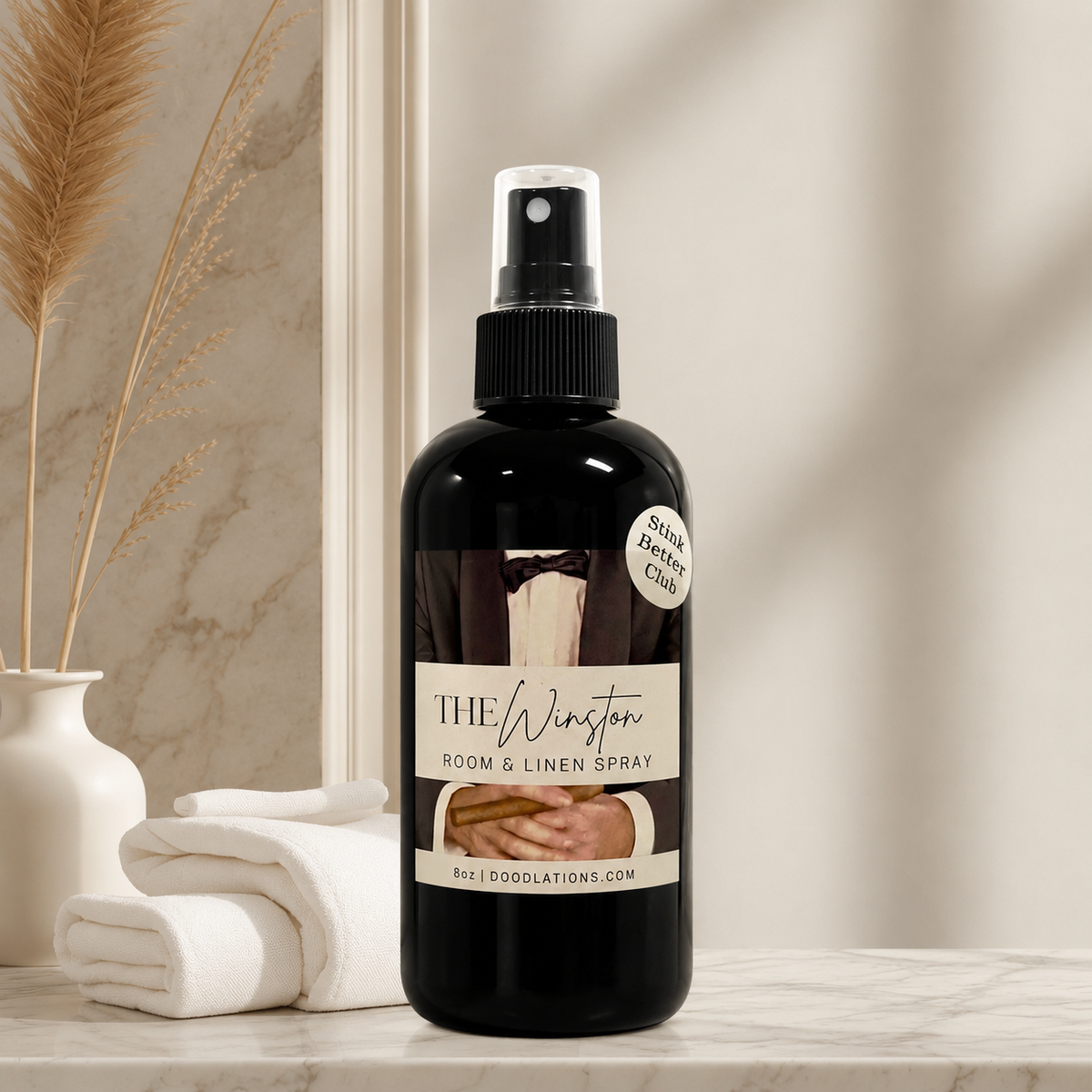 Doodlations Coffee Bar & Boutique The Winston luxury room and linen spray in a black bottle on a marble surface.