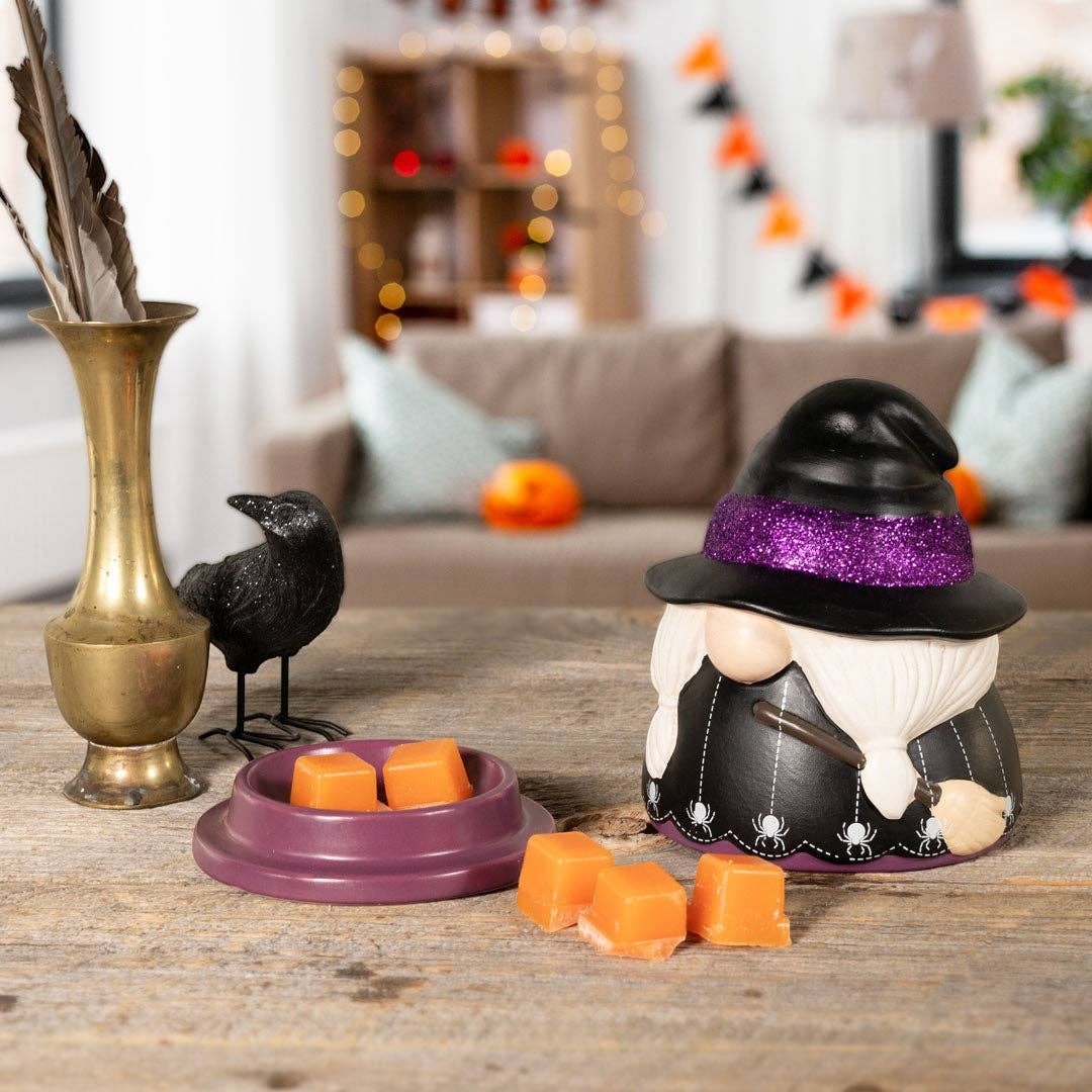Doodlations Coffee Bar & Boutique ceramic witch gnome wax warmer with purple glitter hat and spider web base detail.