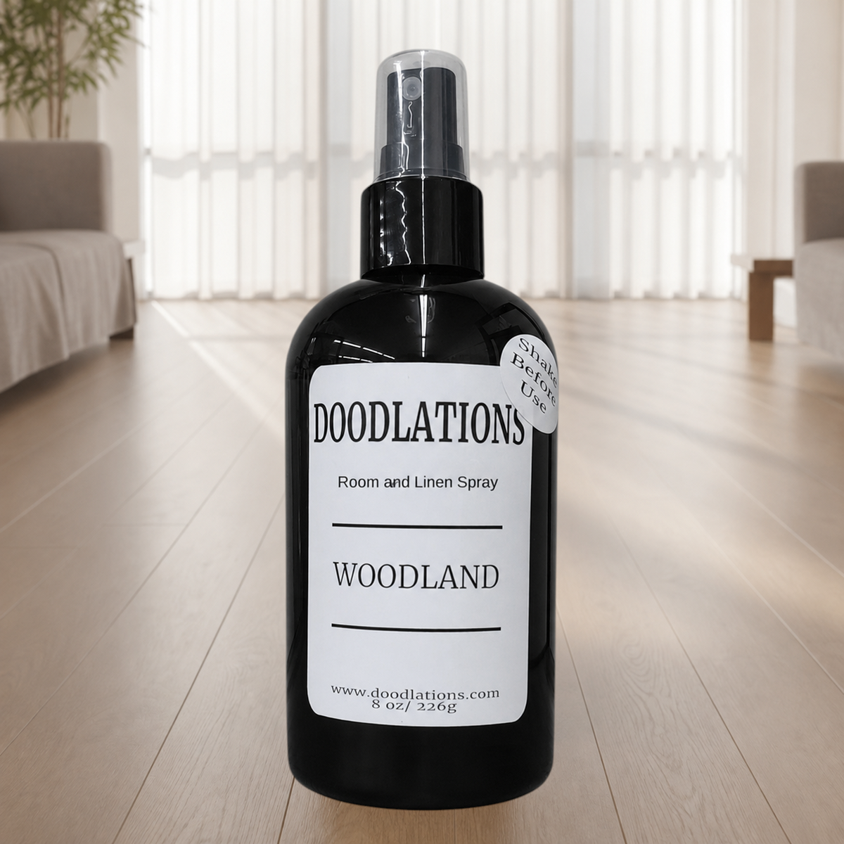 Doodlations Coffee Bar & Boutique Woodland room and linen spray in a black bottle with a minimalist white label.