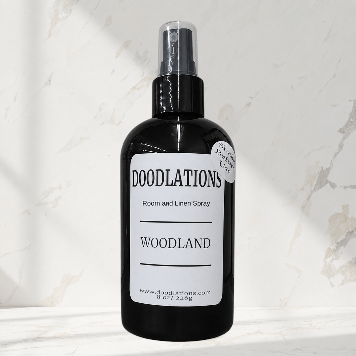Doodlations Coffee Bar & Boutique Woodland room and linen spray in a black bottle with a white label