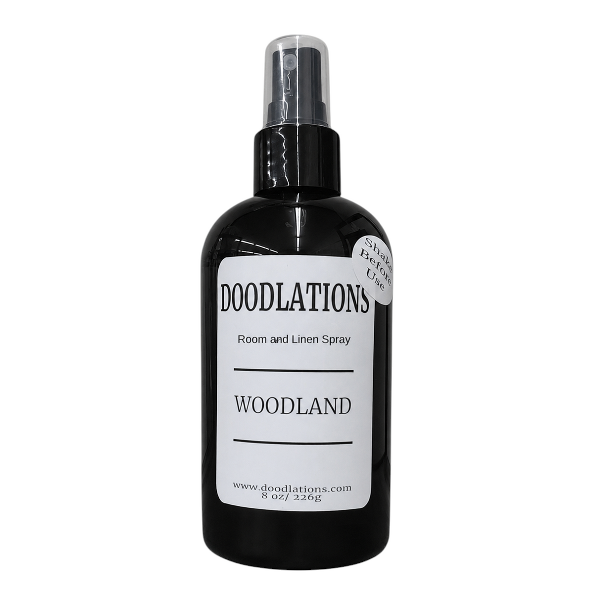 Doodlations Coffee Bar & Boutique Woodland room and linen spray in a black bottle with a white label