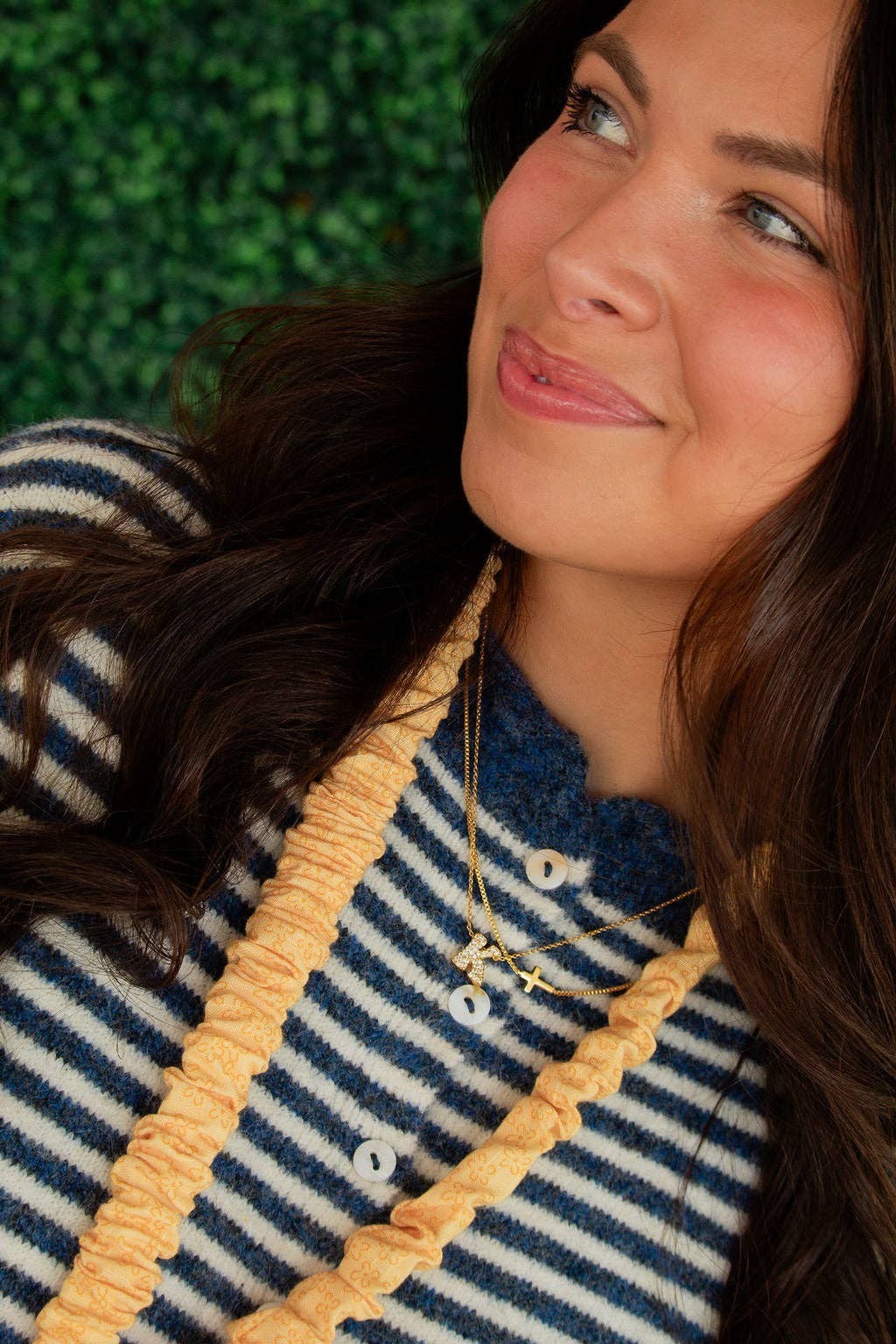 Doodlations Coffee Bar & Boutique Bloom lanyard in yellow floral linen worn by a woman in a striped sweater