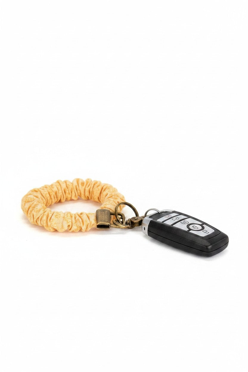 Doodlations Coffee Bar & Boutique yellow floral linen scrunchie keychain with antique brass hardware and car key