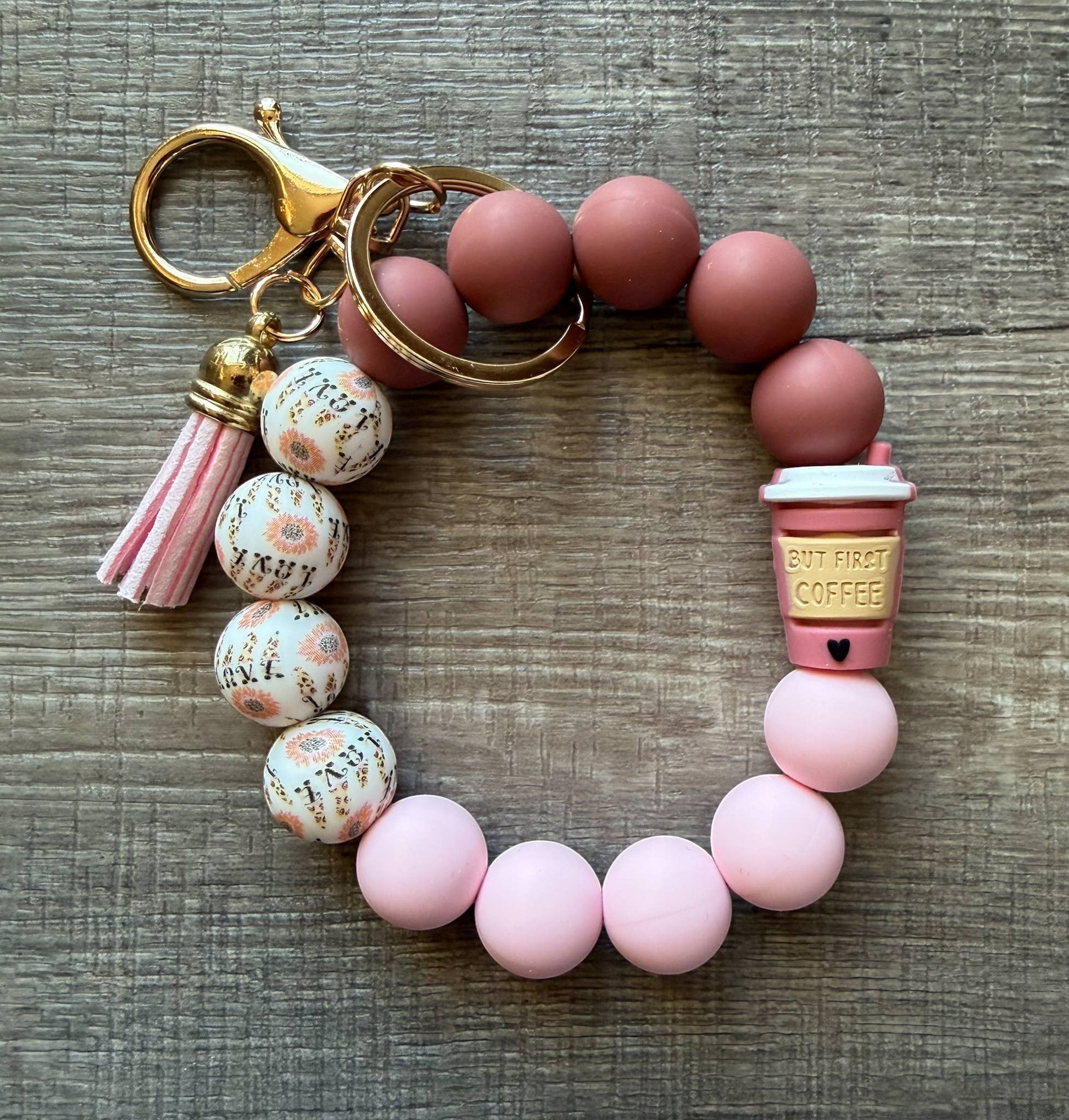 Doodlations Coffee Bar & Boutique beaded keychain bracelet with pink tassel, coffee cup charm, and floral beads.