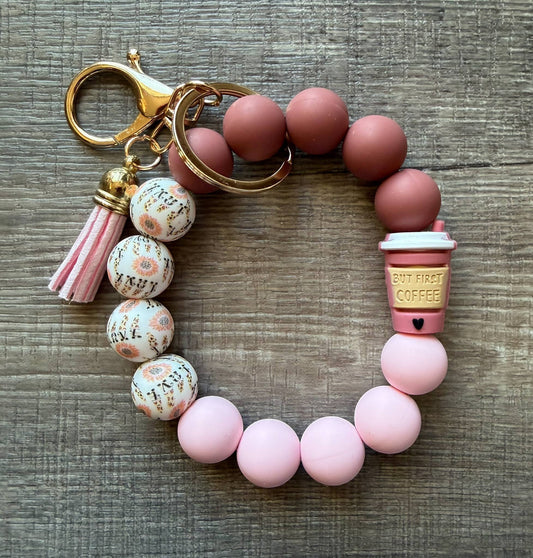Doodlations Coffee Bar & Boutique beaded keychain bracelet with pink tassel, coffee cup charm, and floral beads.