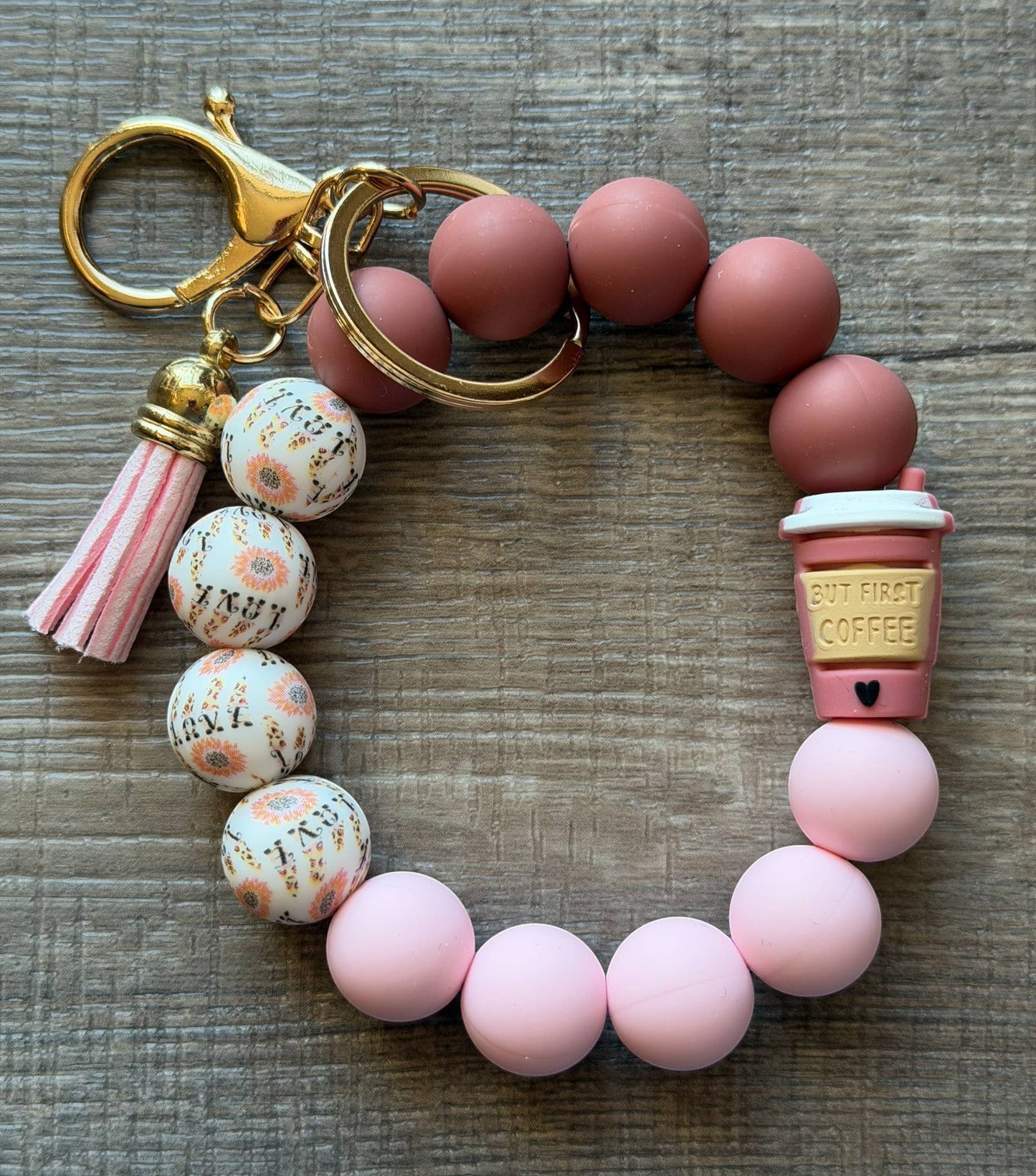 Doodlations Coffee Bar & Boutique beaded keychain bracelet with pink tassel, coffee cup charm, and floral beads.