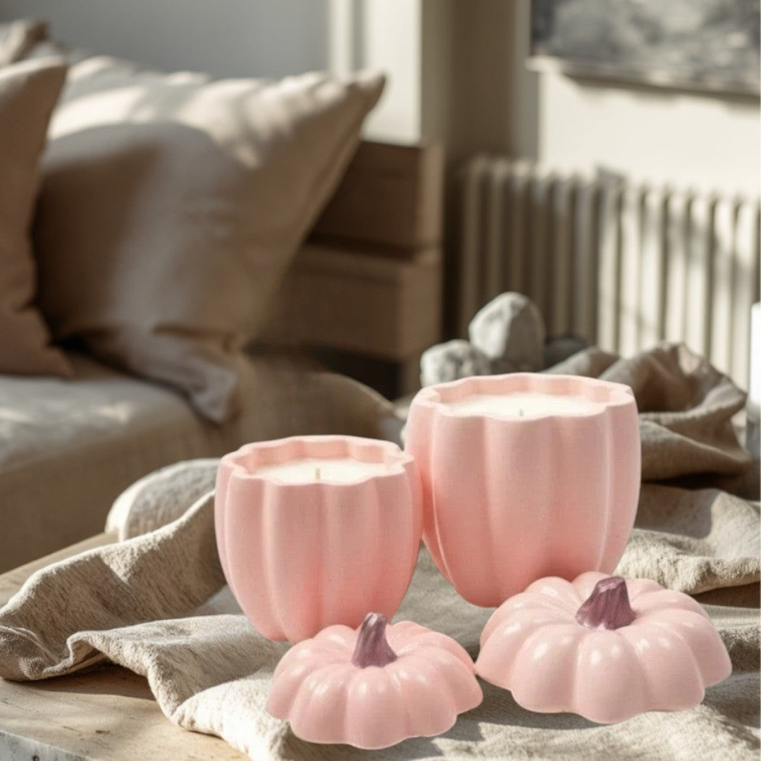 Doodlations pink concrete pumpkin candles in two sizes, with decorative lids.