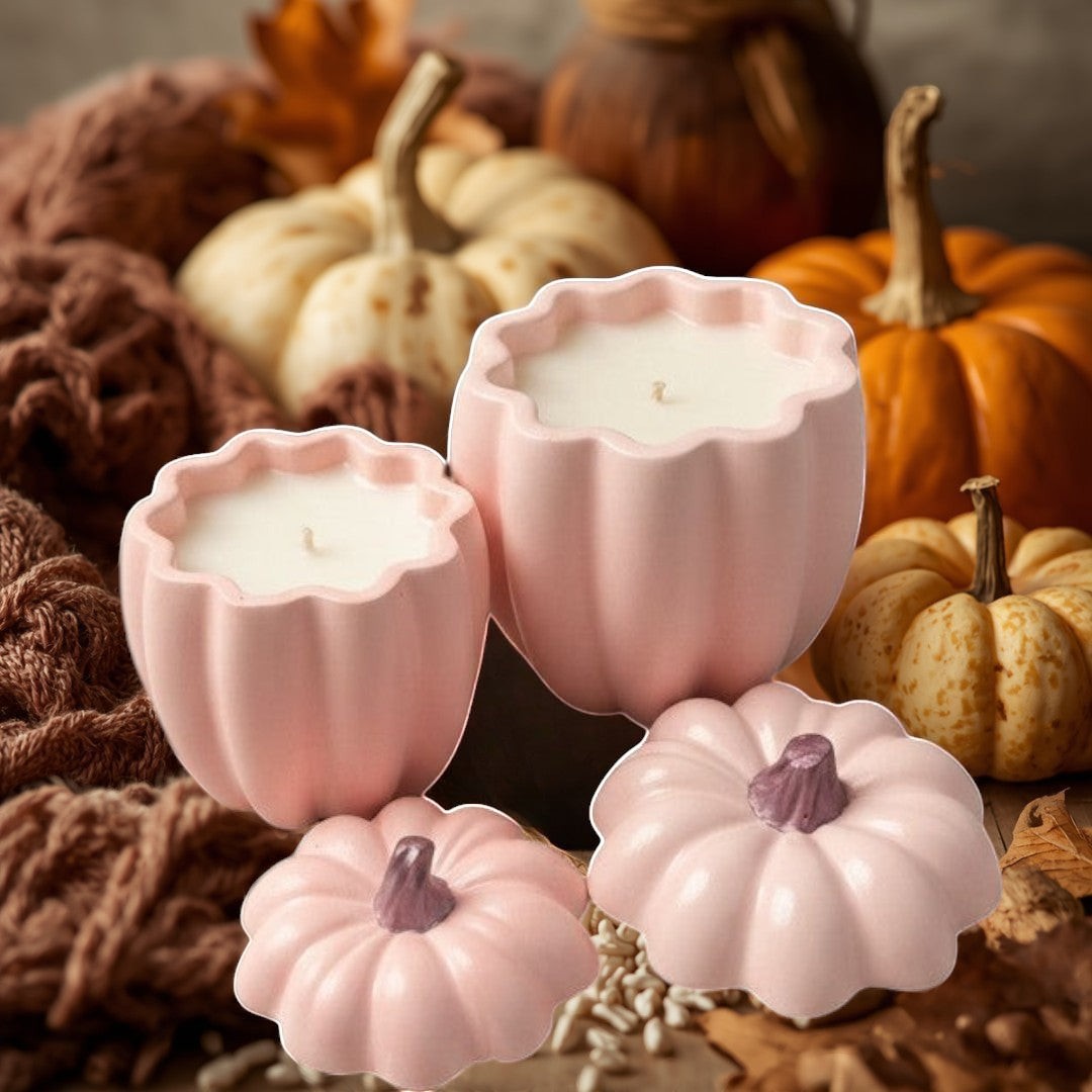 Doodlations pink concrete pumpkin candles in two sizes, with decorative pumpkin lids.